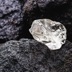 Rough diamond on black stone